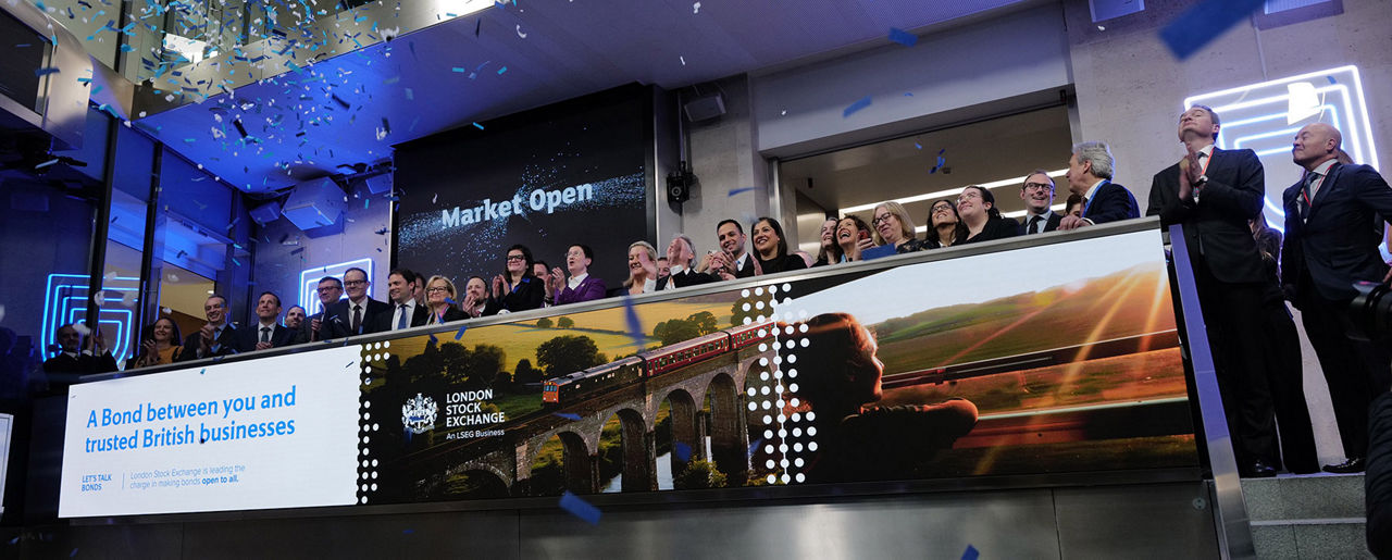 The team celebrating on the balcony at LSEG during the welcome ceremony.