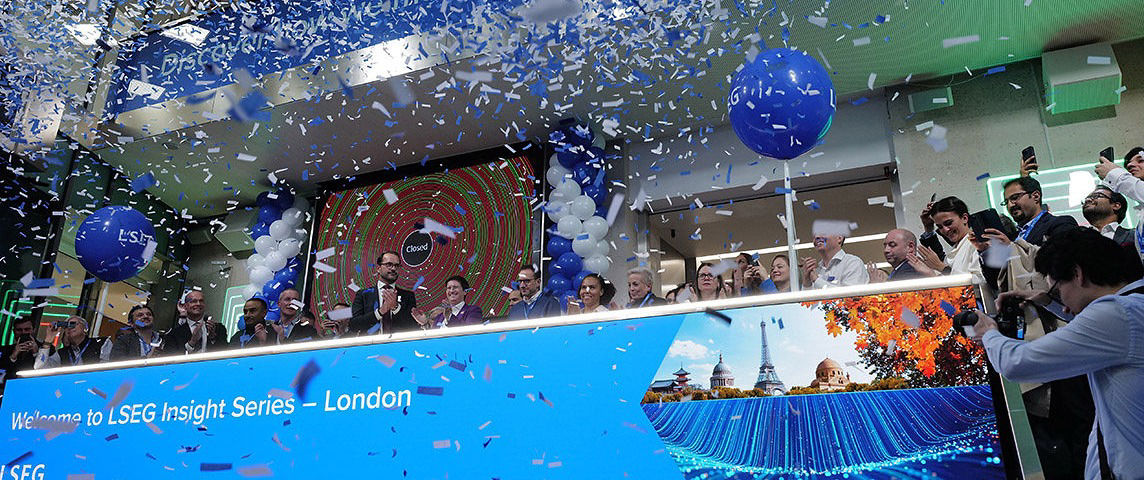The team celebrating on the balcony at LSEG during the welcome ceremony.