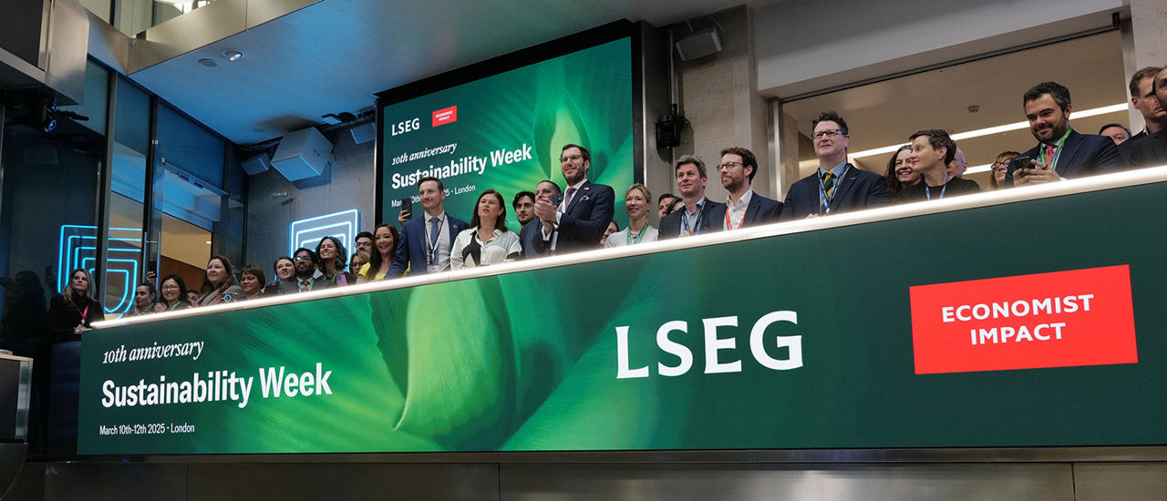 The team celebrating on the balcony at LSEG during the welcome ceremony.
