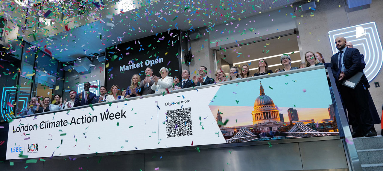The team celebrating on the balcony at LSEG during the welcome ceremony.