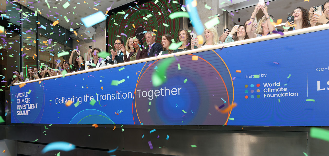The team celebrating on the balcony at LSEG during the welcome ceremony.