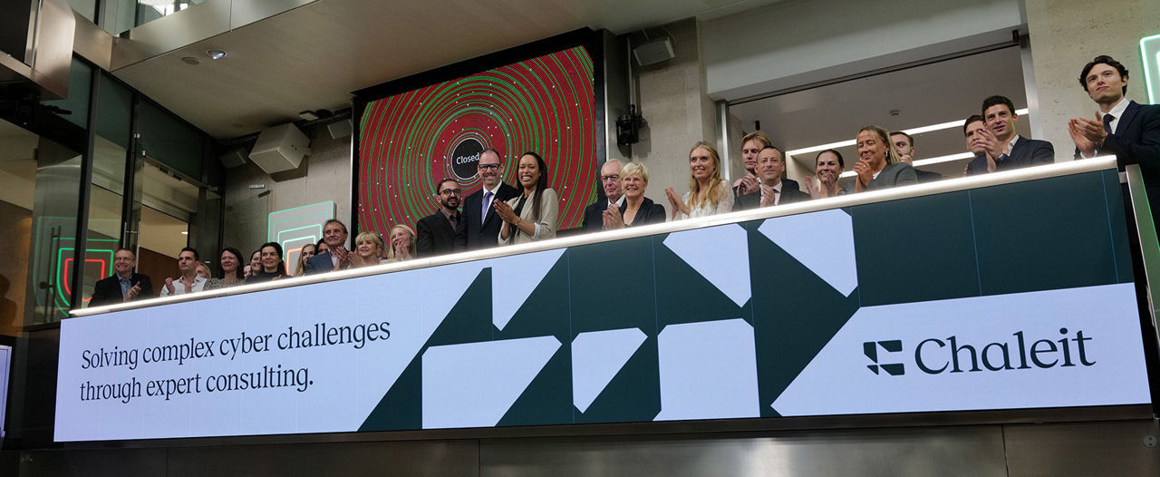 The team celebrating on the balcony at LSEG during the welcome ceremony.