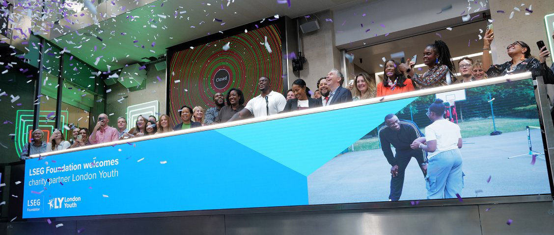 The team celebrating on the balcony at LSEG during the welcome ceremony.