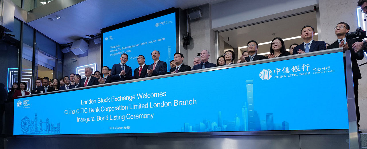 The team celebrating on the balcony at LSEG during the welcome ceremony.