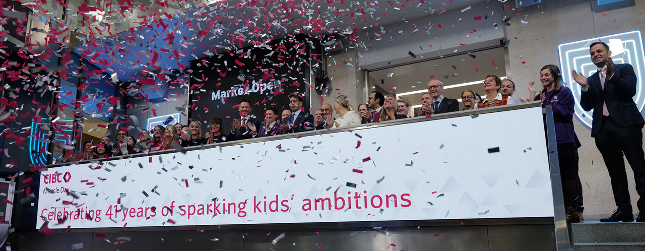 The team celebrating on the balcony at LSEG during the welcome ceremony.