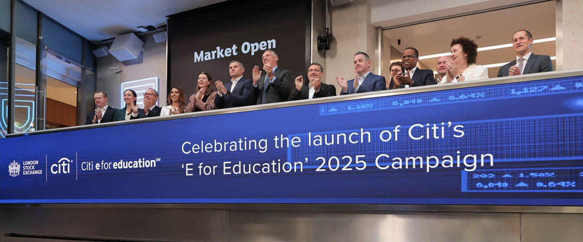 The team celebrating on the balcony at LSEG during the welcome ceremony