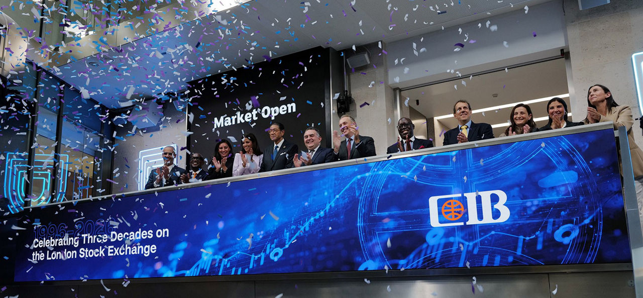 The team celebrating on the balcony at LSEG during the welcome ceremony.