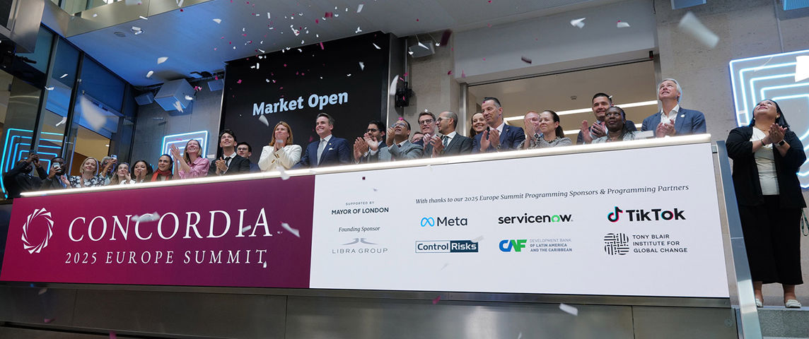 The team celebrating on the balcony at LSEG during the welcome ceremony.