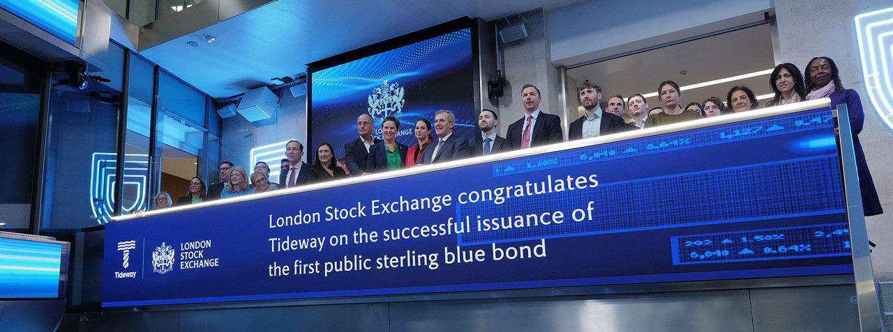 The team celebrating on the balcony at LSEG during the welcome ceremony.