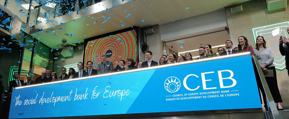 The team celebrating on the balcony at LSEG during the welcome ceremony.