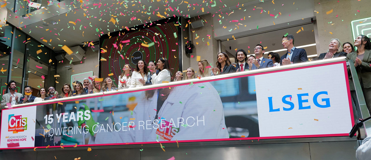 The team celebrating on the balcony at LSEG during the welcome ceremony.
