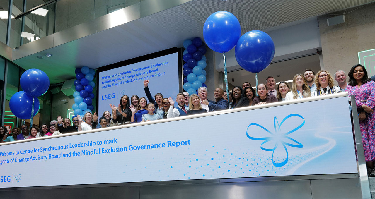 The team celebrating on the balcony at LSEG during the welcome ceremony.
