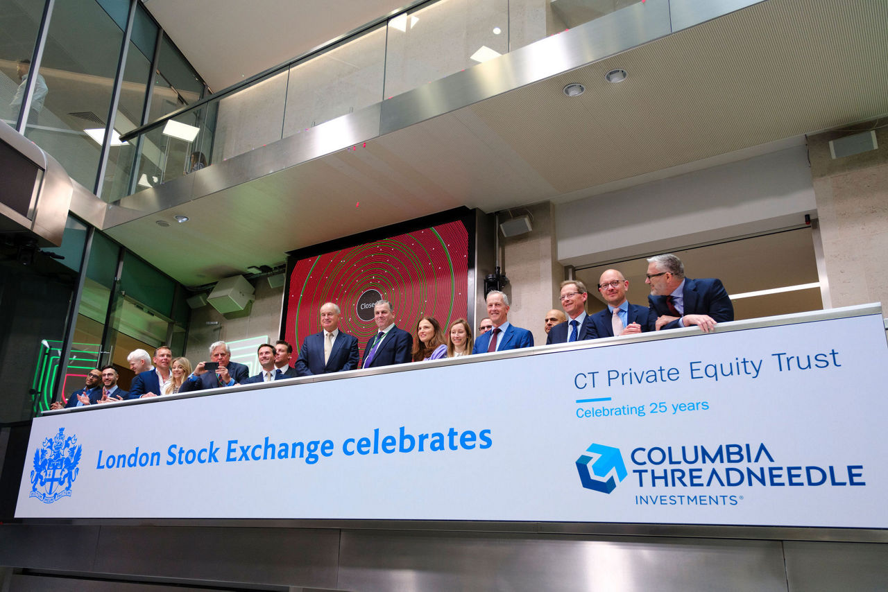 The team celebrating on the balcony at LSEG during the welcome ceremony.