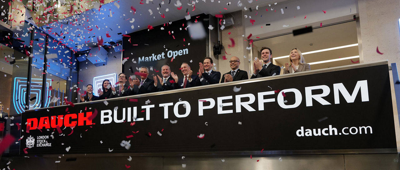The team celebrating on the balcony at LSEG during the welcome ceremony.