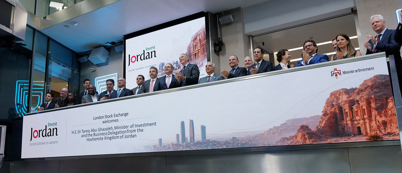 The team celebrating on the balcony at LSEG during the welcome ceremony.