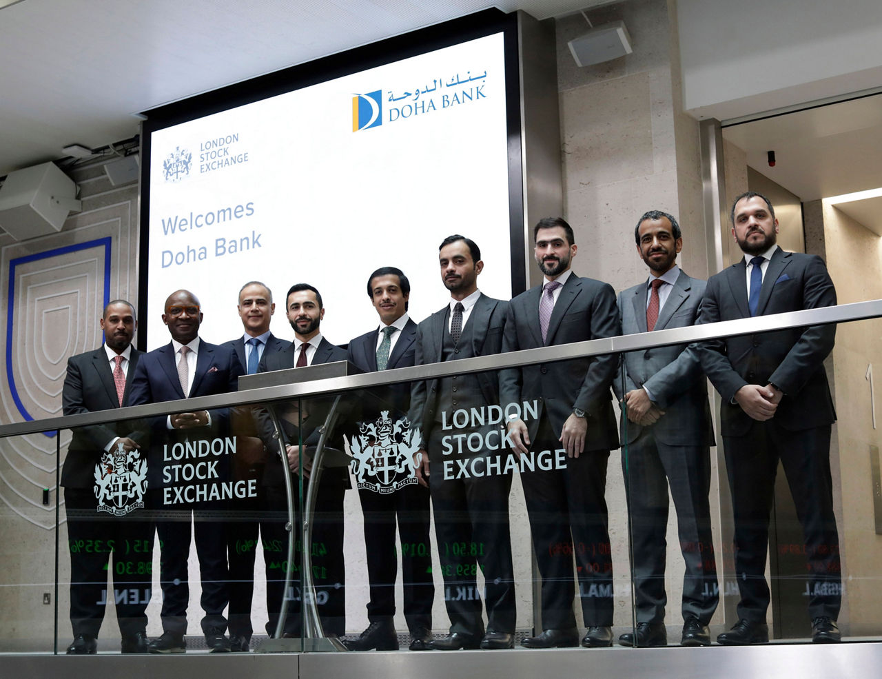 The team celebrating on the balcony at LSEG during the welcome ceremony.