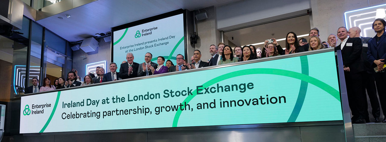 The team celebrating on the balcony at LSEG during the welcome ceremony.