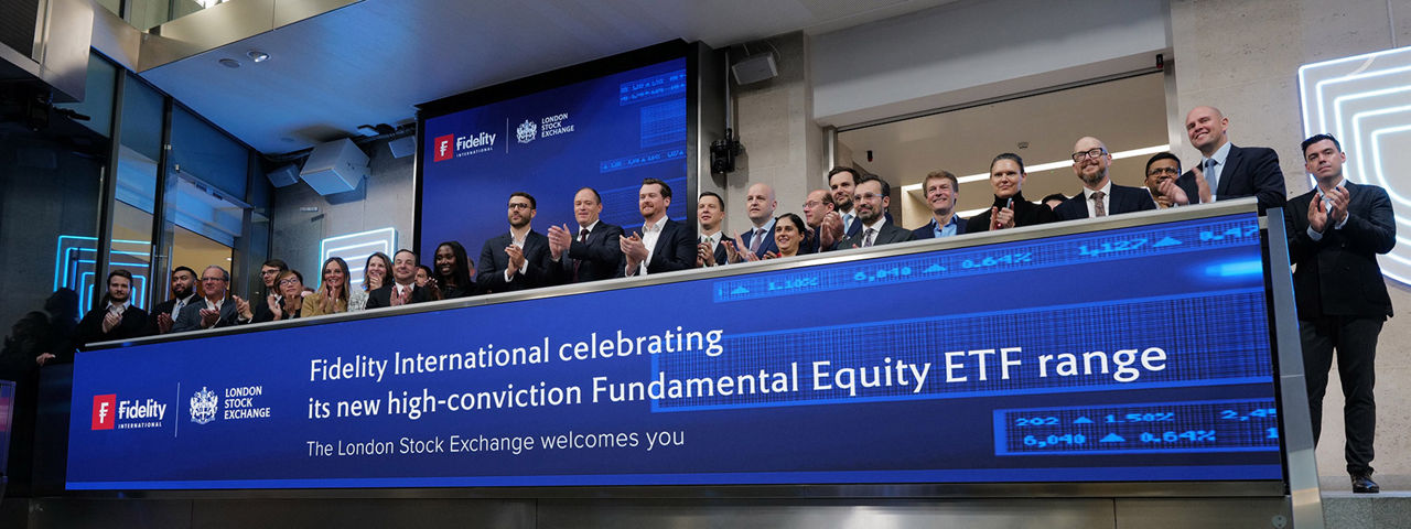 The team celebrating on the balcony at LSEG during the welcome ceremony.