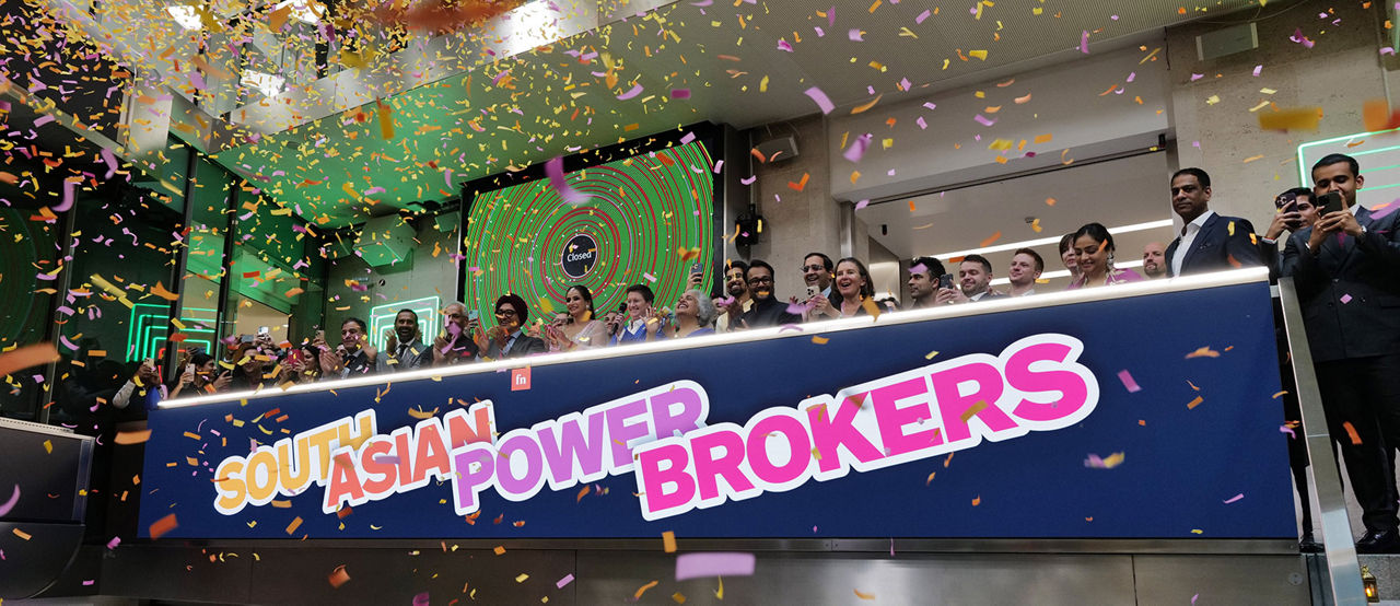 The team celebrating on the balcony at LSEG during the welcome ceremony.