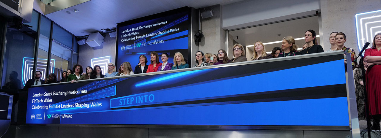 The team celebrating on the balcony at LSEG during the welcome ceremony.
