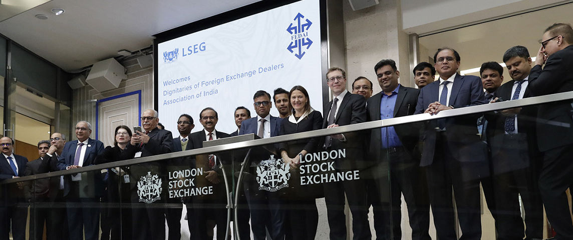 The team celebrating on the balcony at LSEG during the welcome ceremony.