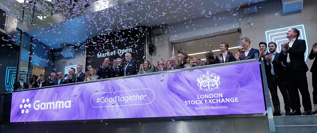 The team celebrating on the balcony at LSEG during the welcome ceremony.