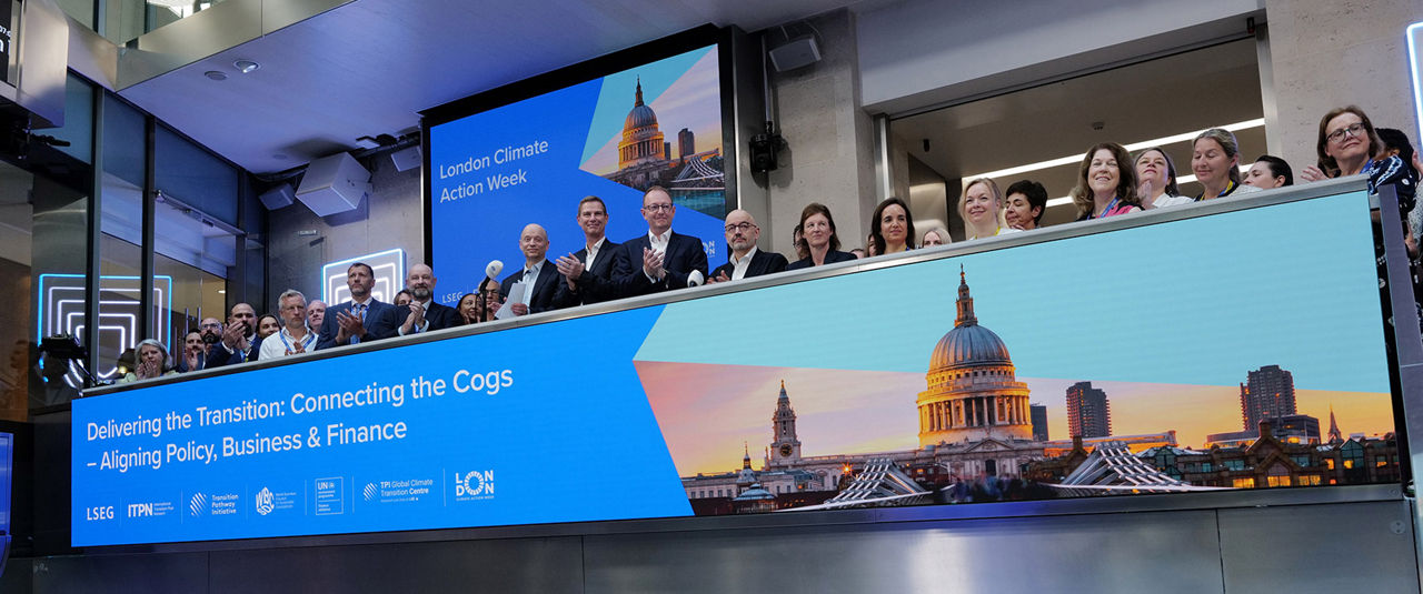 The team celebrating on the balcony at LSEG during the welcome ceremony.