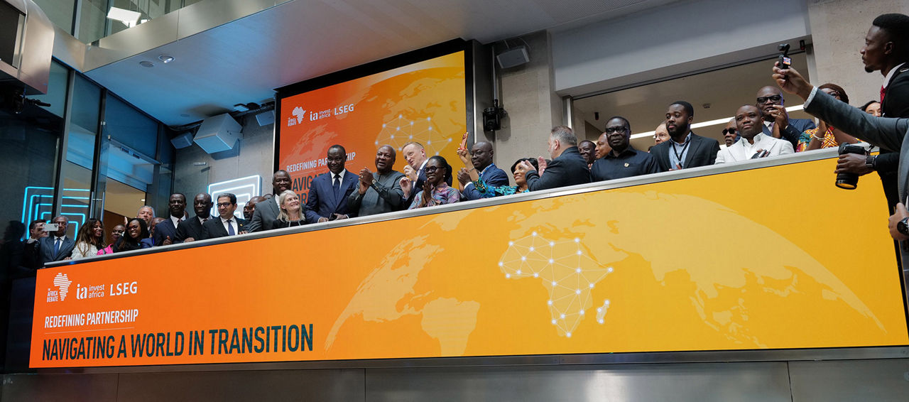 The team celebrating on the balcony at LSEG during the welcome ceremony.