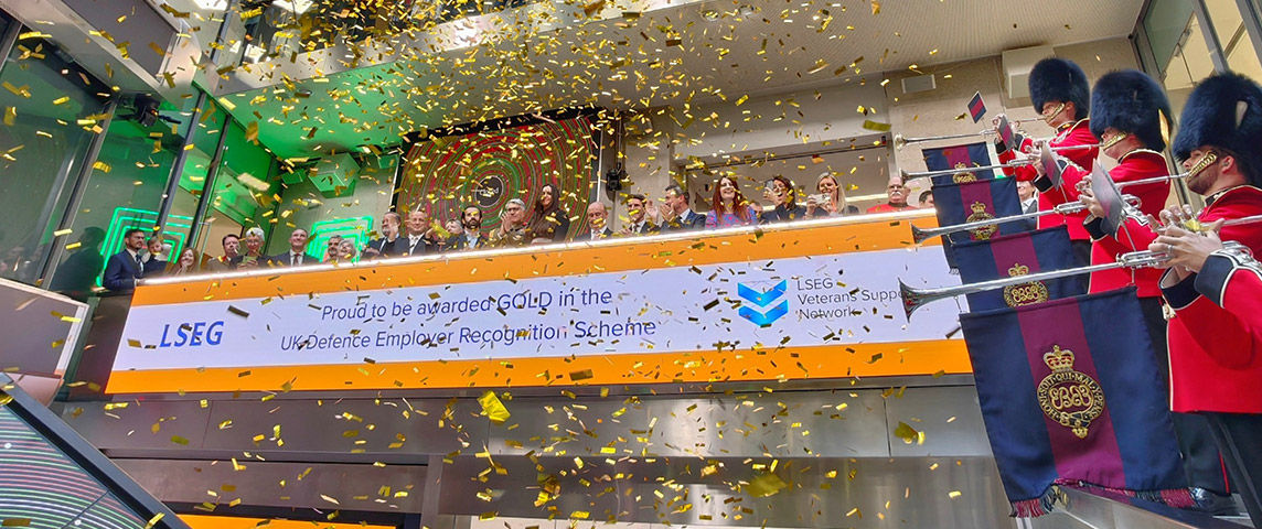 The team celebrating on the balcony at LSEG during the welcome ceremony.