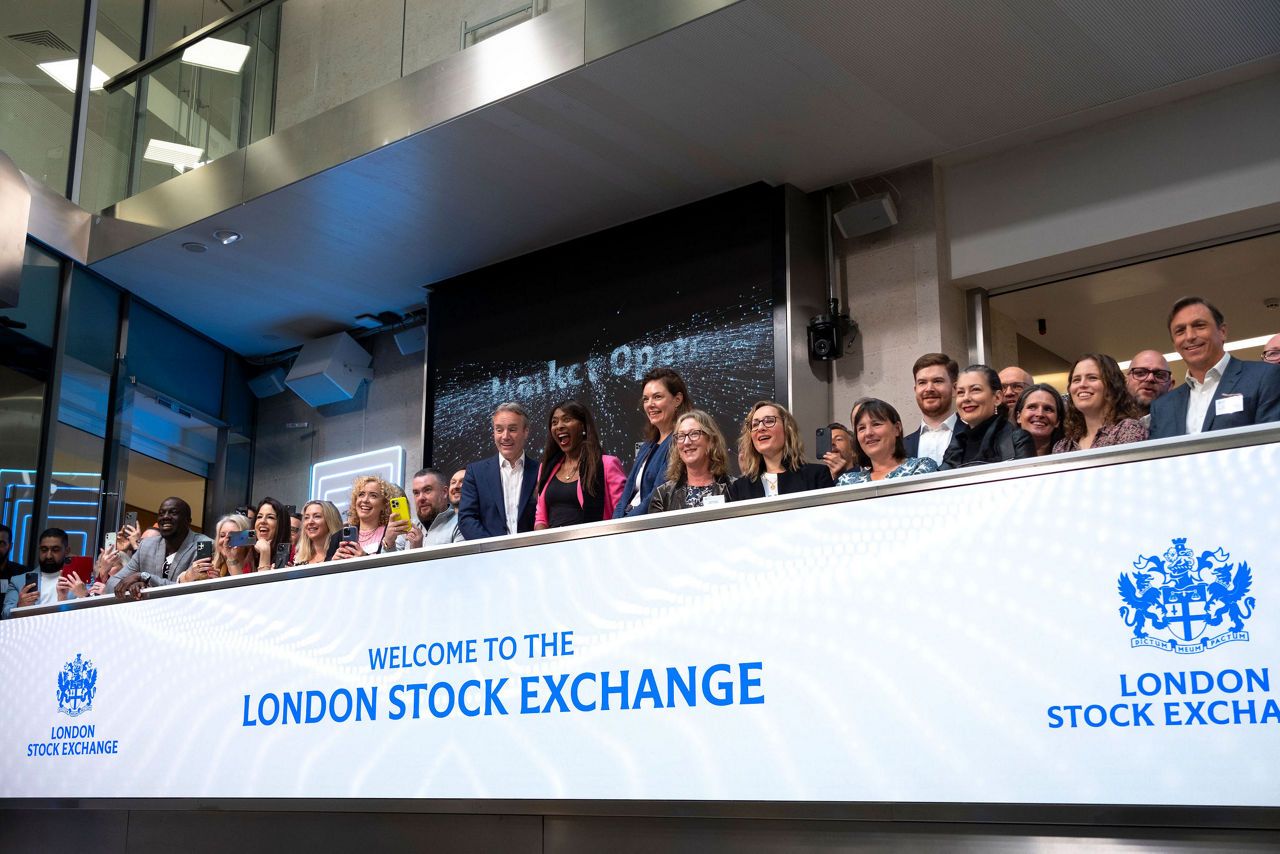 The team celebrating on the balcony at LSEG during the welcome ceremony.