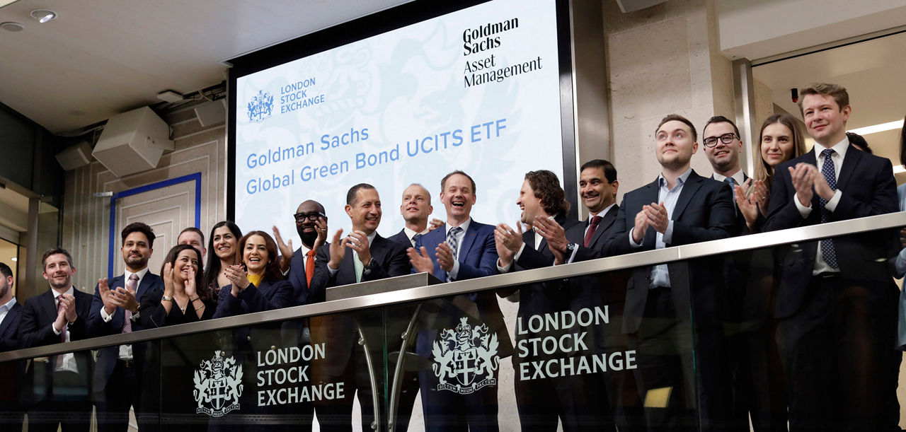The team celebrating on the balcony at LSEG during the welcome ceremony.
