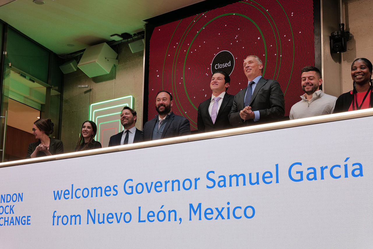 The team celebrating on the balcony at LSEG during the welcome ceremony.