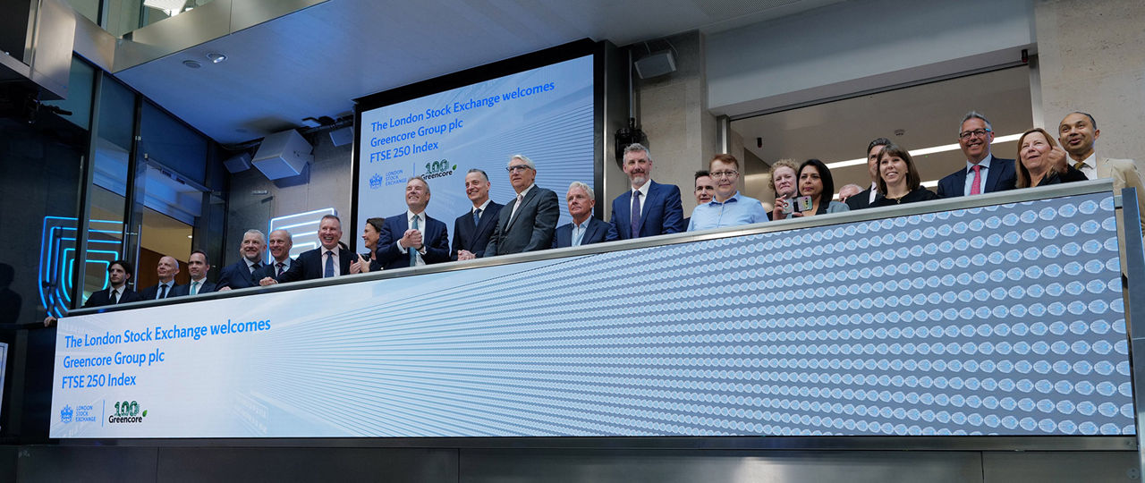 The team celebrating on the balcony at LSEG during the welcome ceremony.