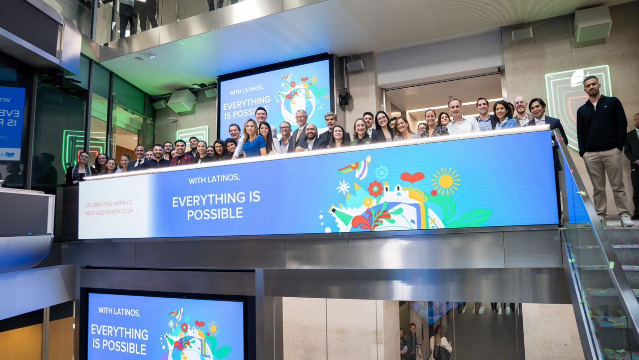 The team celebrating on the balcony at LSEG during the welcome ceremony.