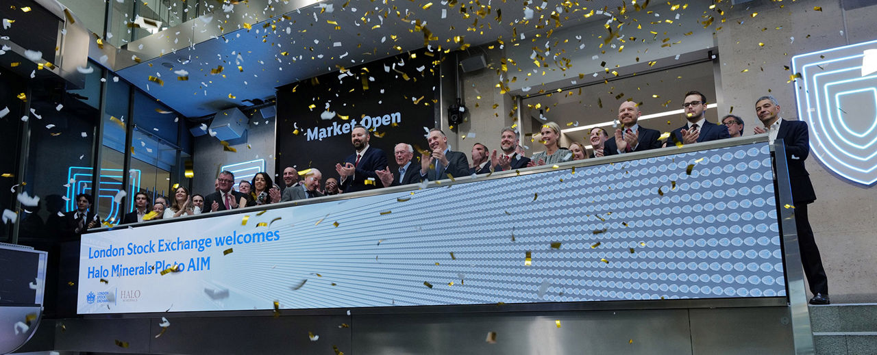 The team celebrating on the balcony at LSEG during the welcome ceremony.