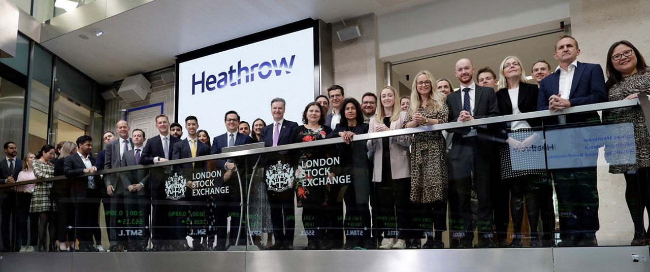 The team celebrating on the balcony at LSEG during the welcome ceremony.