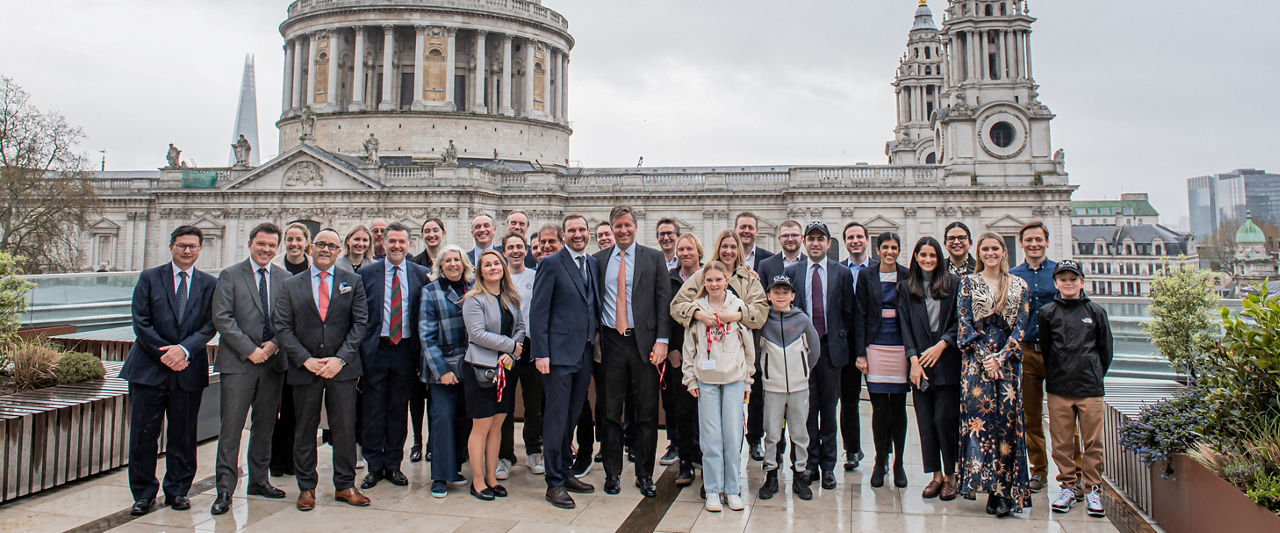 The team celebrating on the balcony at LSEG during the welcome ceremony.
