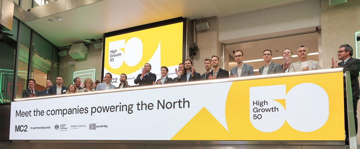 The team celebrating on the balcony at LSEG during the welcome ceremony.