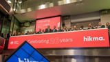 The team celebrating on the balcony at LSEG during the welcome ceremony.
