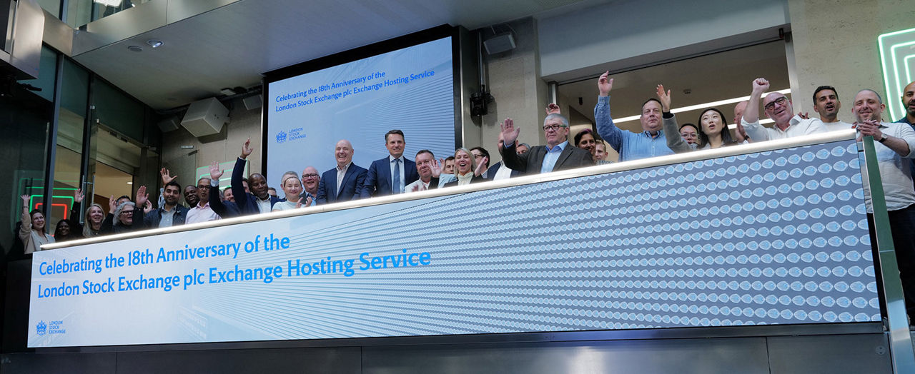 The team celebrating on the balcony at LSEG during the welcome ceremony.
