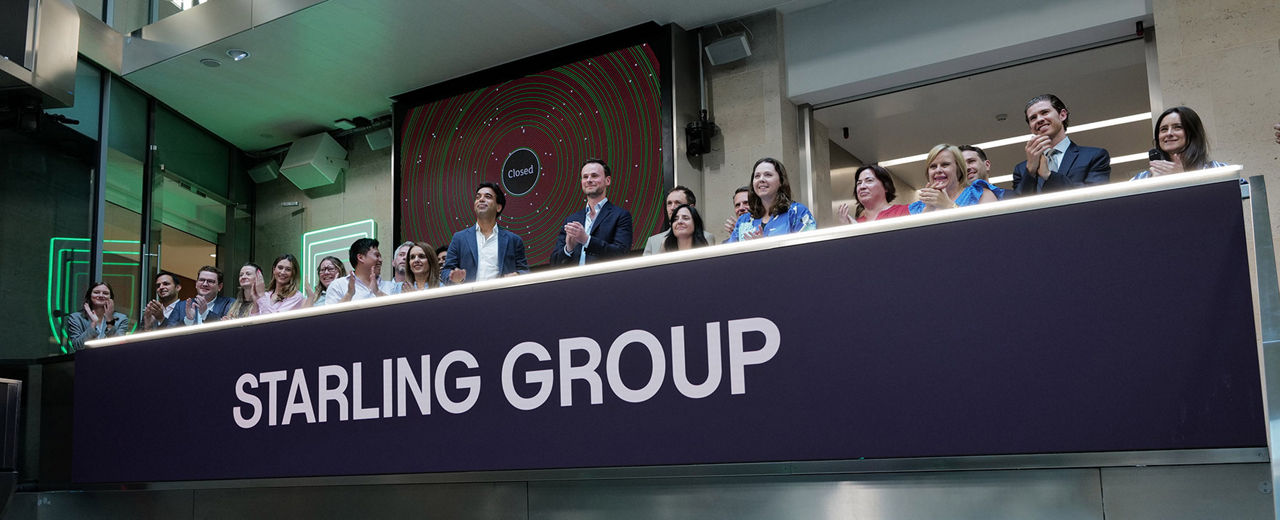 The team celebrating on the balcony at LSEG during the welcome ceremony.