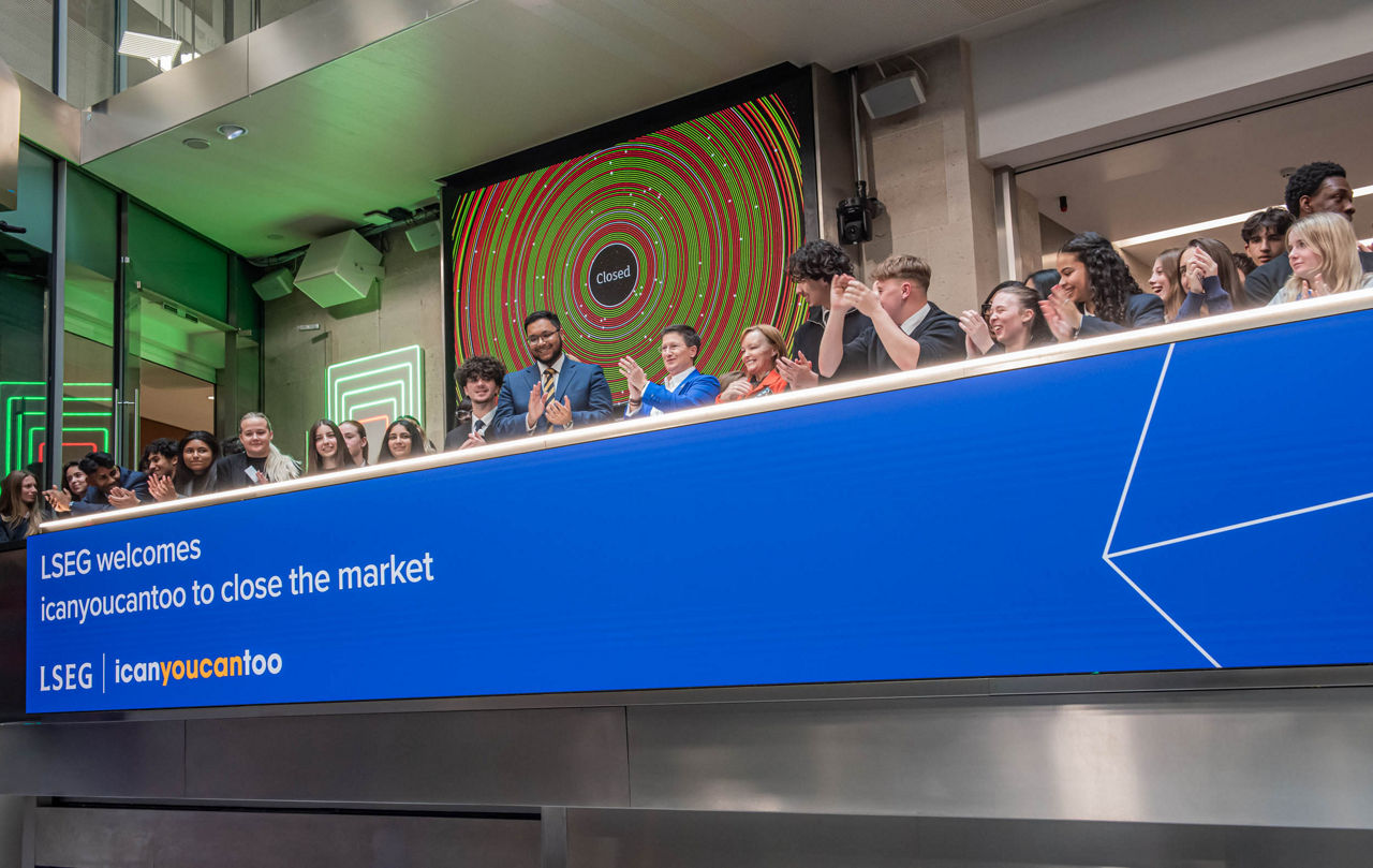 The team celebrating on the balcony at LSEG during the welcome ceremony.