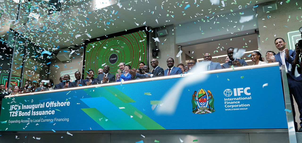 The team celebrating on the balcony at LSEG during the welcome ceremony.