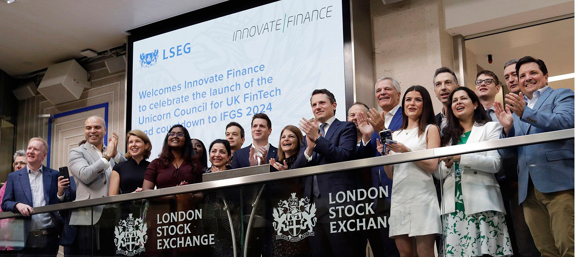 The team celebrating on the balcony at LSEG during the welcome ceremony.