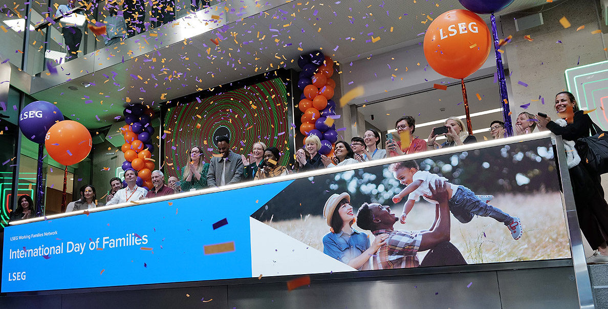 The team celebrating on the balcony at LSEG during the welcome ceremony.