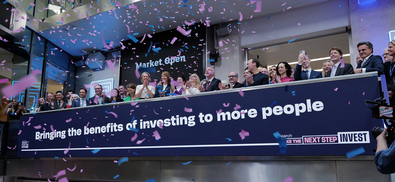 The team celebrating on the balcony at LSEG during the welcome ceremony.