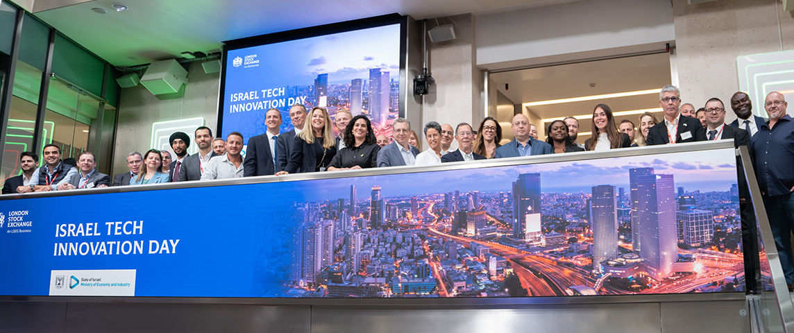 The team celebrating on the balcony at LSEG during the welcome ceremony.