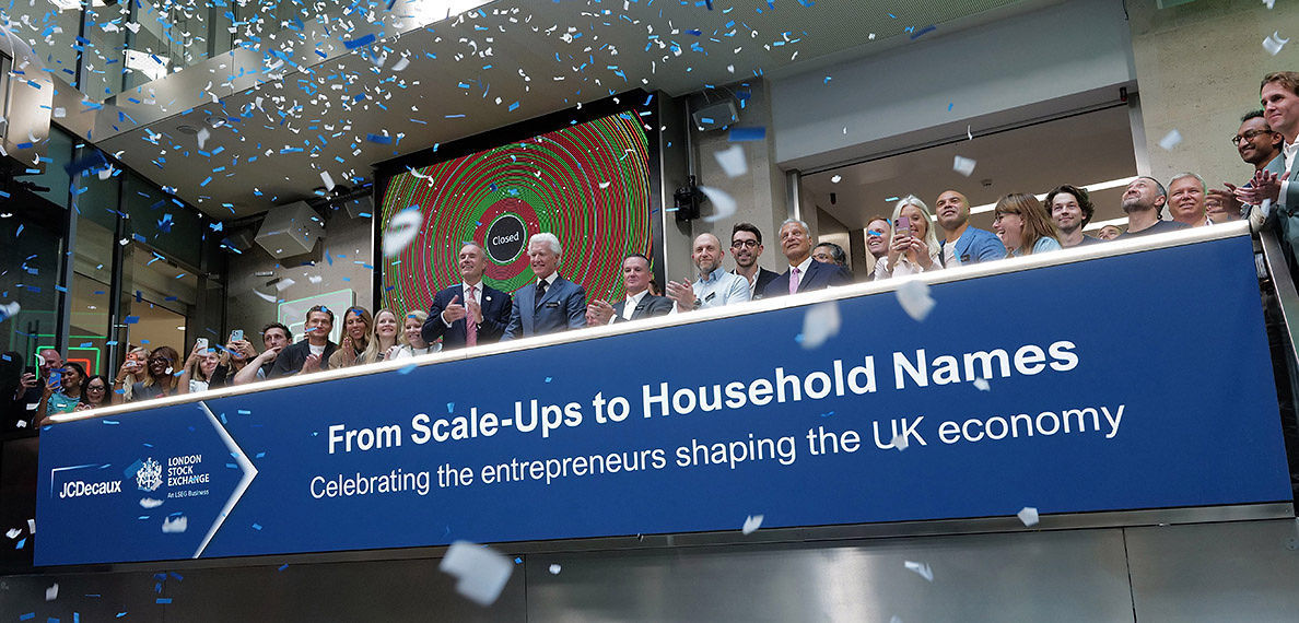 The team celebrating on the balcony at LSEG during the welcome ceremony.