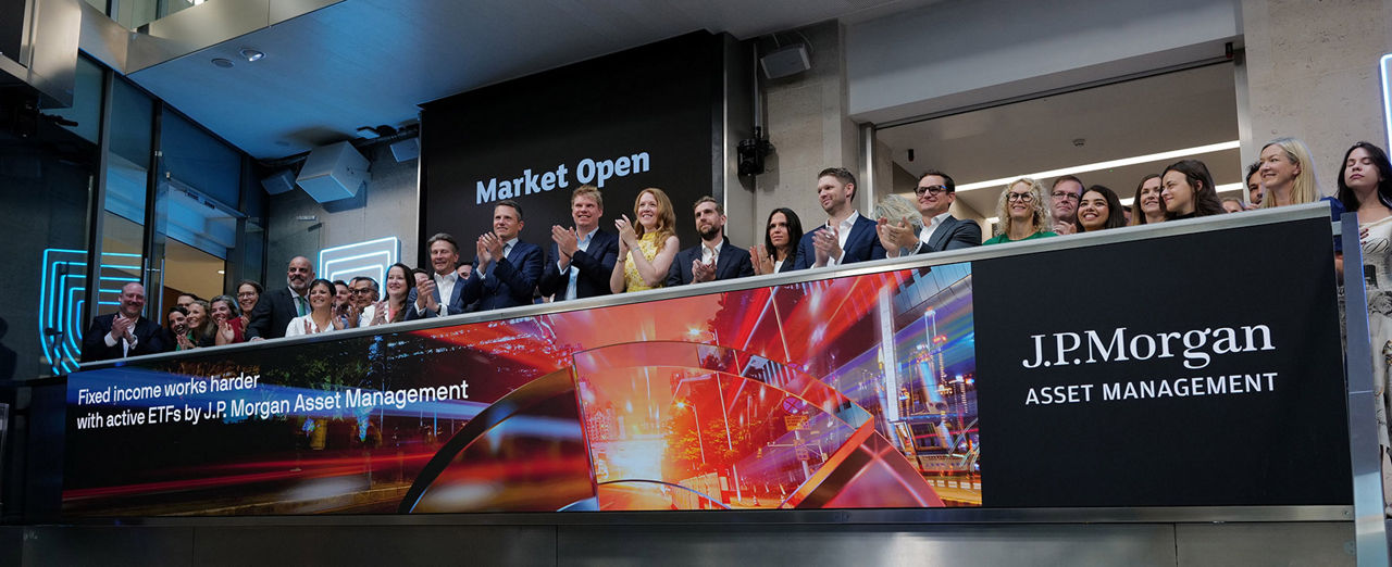 The team celebrating on the balcony at LSEG during the welcome ceremony.