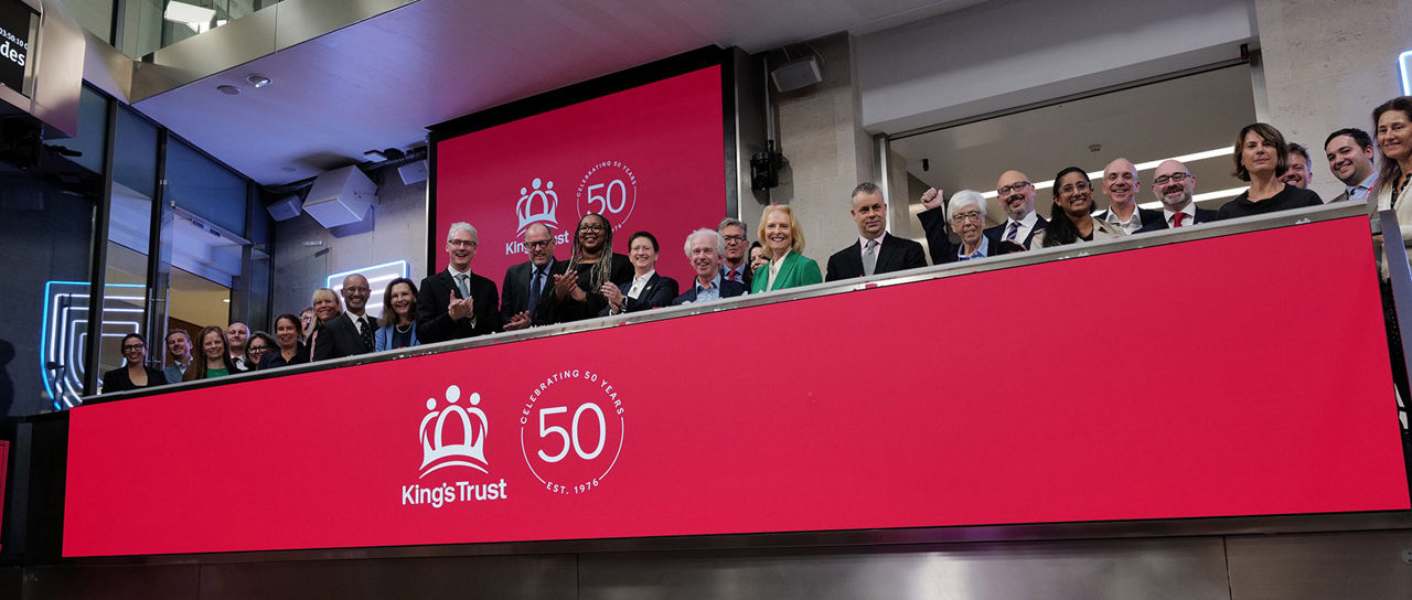The team celebrating on the balcony at LSEG during the welcome ceremony.